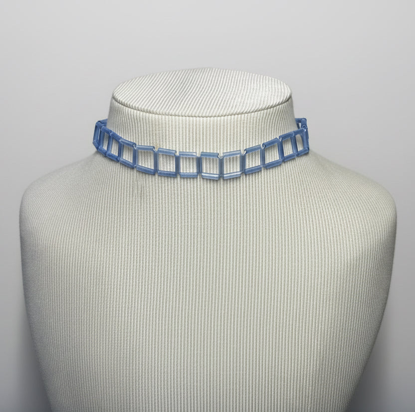 Periwinkle chain choker on a mannequin neck against a gray background